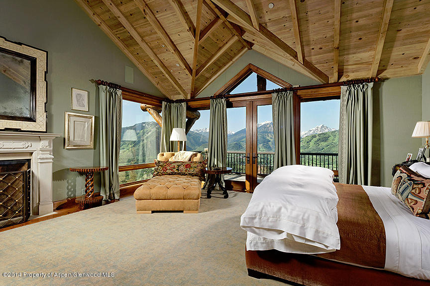 189 Larson Road Aspen, CO 81612 - Photo 20 of 28 a spacious bedroom with a bed and large windows