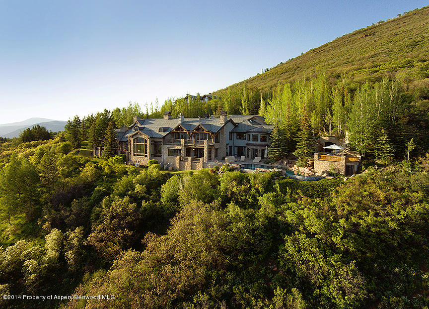 189 Larson Road Aspen, CO 81612 - Photo 2 of 28 a view of a swimming pool with lawn chairs and wooden fence