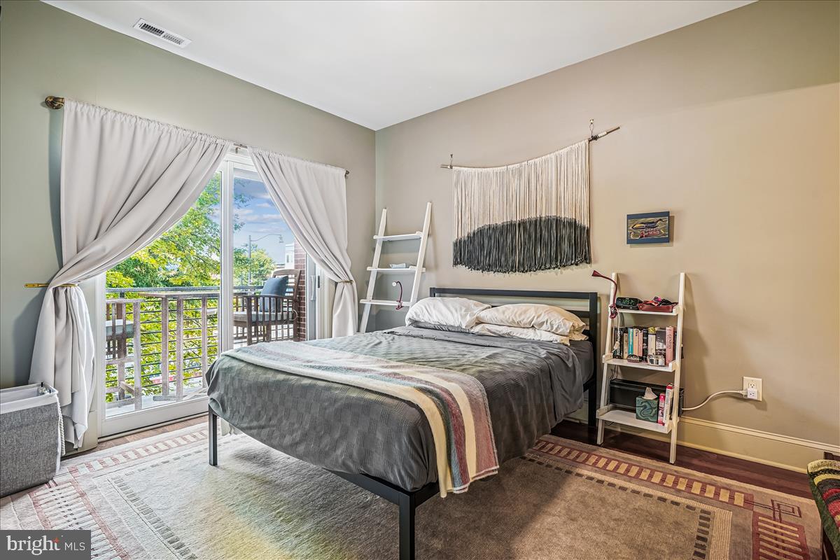 1301 H Street Northeast, Unit 2 Washington, DC 20002 - Photo 13 of 36 a bedroom with a bed and a large window