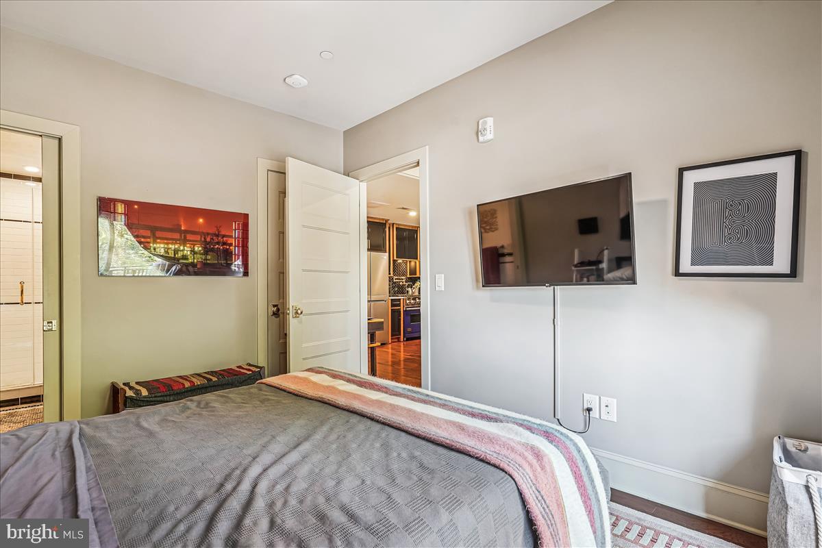 1301 H Street Northeast, Unit 2 Washington, DC 20002 - Photo 15 of 36 a bedroom with a bed and a flat screen tv