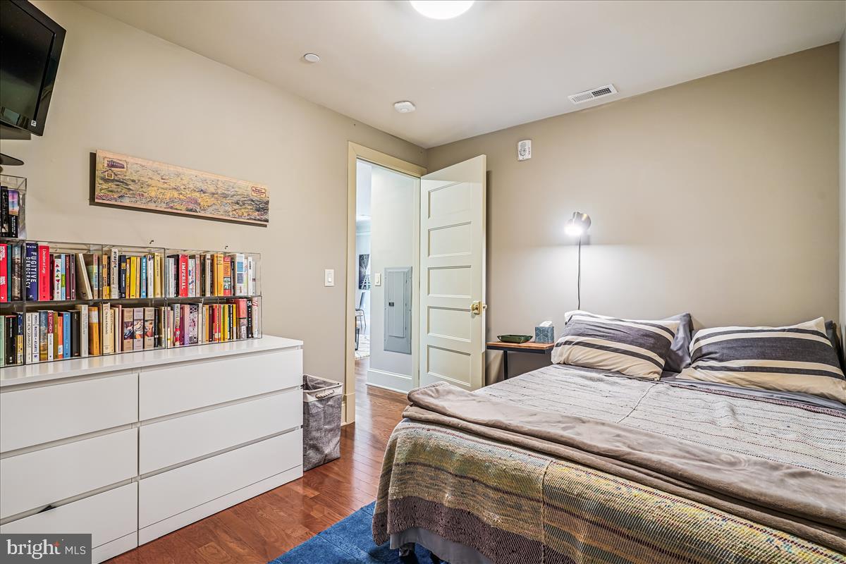 1301 H Street Northeast, Unit 2 Washington, DC 20002 - Photo 25 of 36 a bedroom with a bed and a book shelf