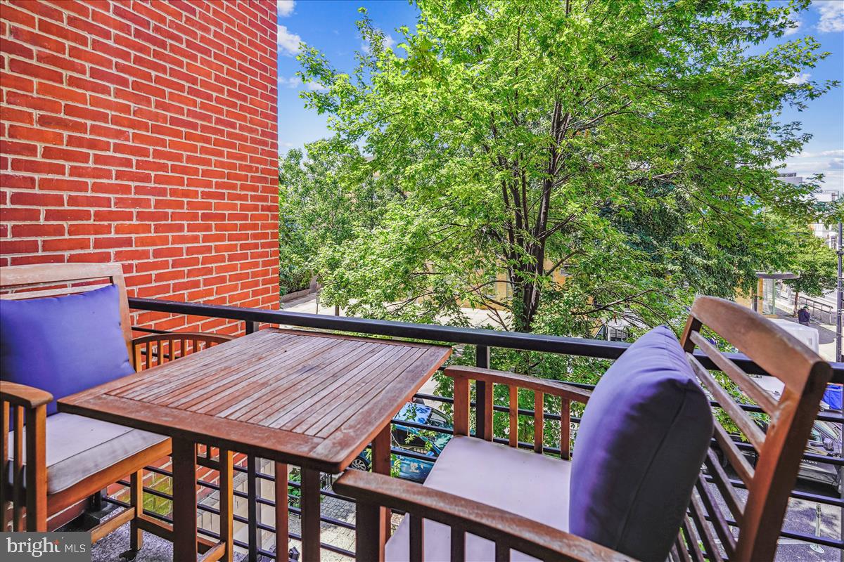 1301 H Street Northeast, Unit 2 Washington, DC 20002 - Photo 28 of 36 a view of a wooden chairs and table in patio