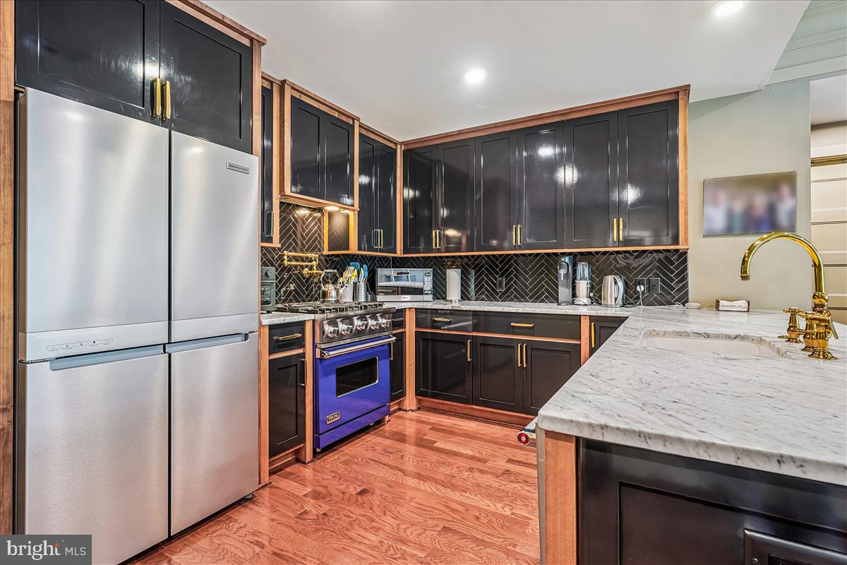 1301 H Street Northeast, Unit 2 Washington, DC 20002 - Photo 7 of 36 a kitchen with stainless steel appliances granite countertop a refrigerator and a sink