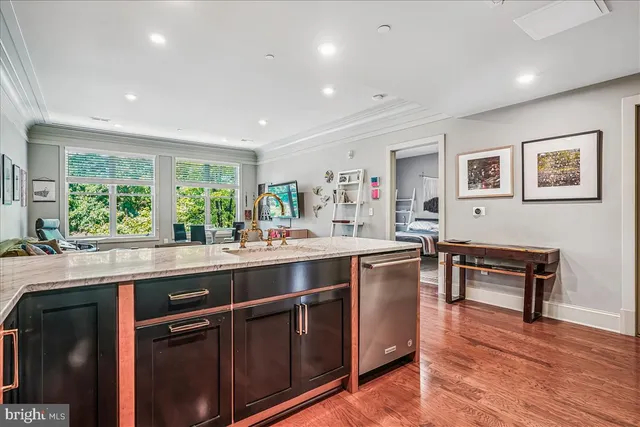 a kitchen with a sink stove and wooden cabinets