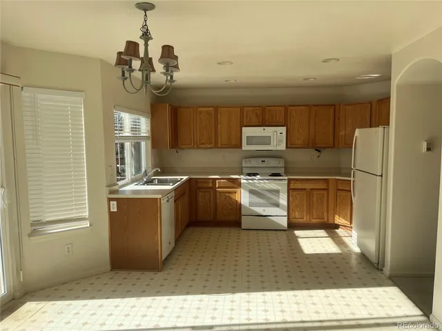 a kitchen with a refrigerator a sink and dishwasher