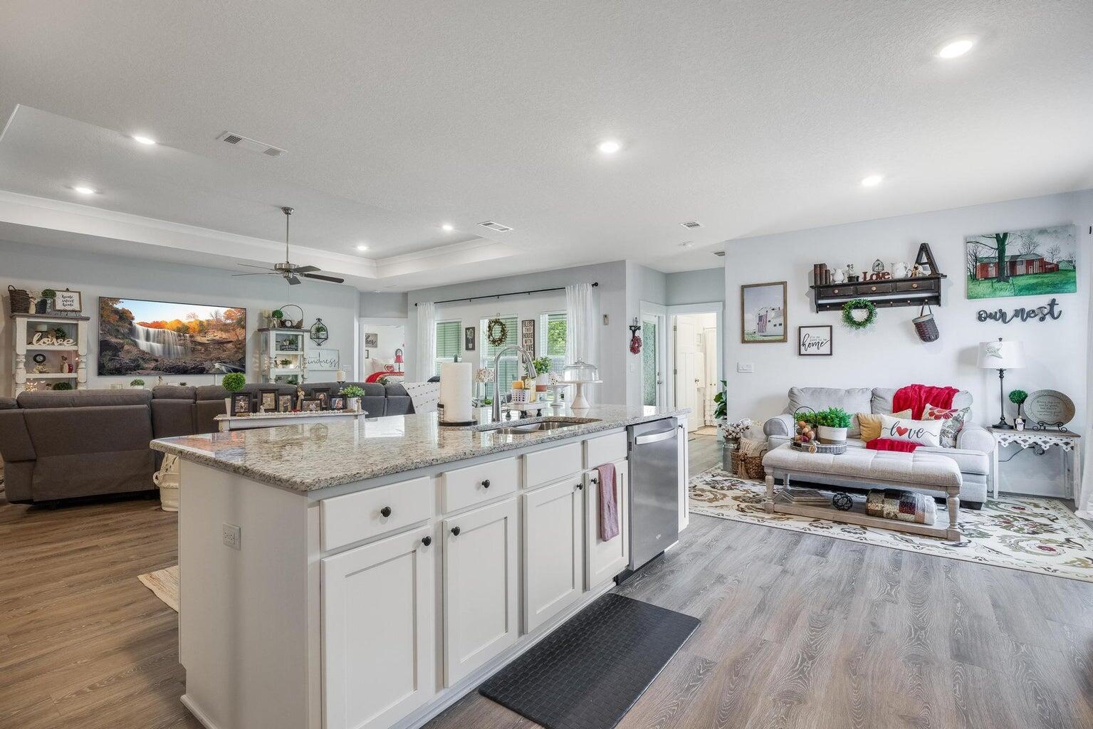 519 Mary Lou Way Crestview, FL 32539 - Photo 14 of 53 a kitchen with kitchen island granite countertop a sink cabinets and wooden floor