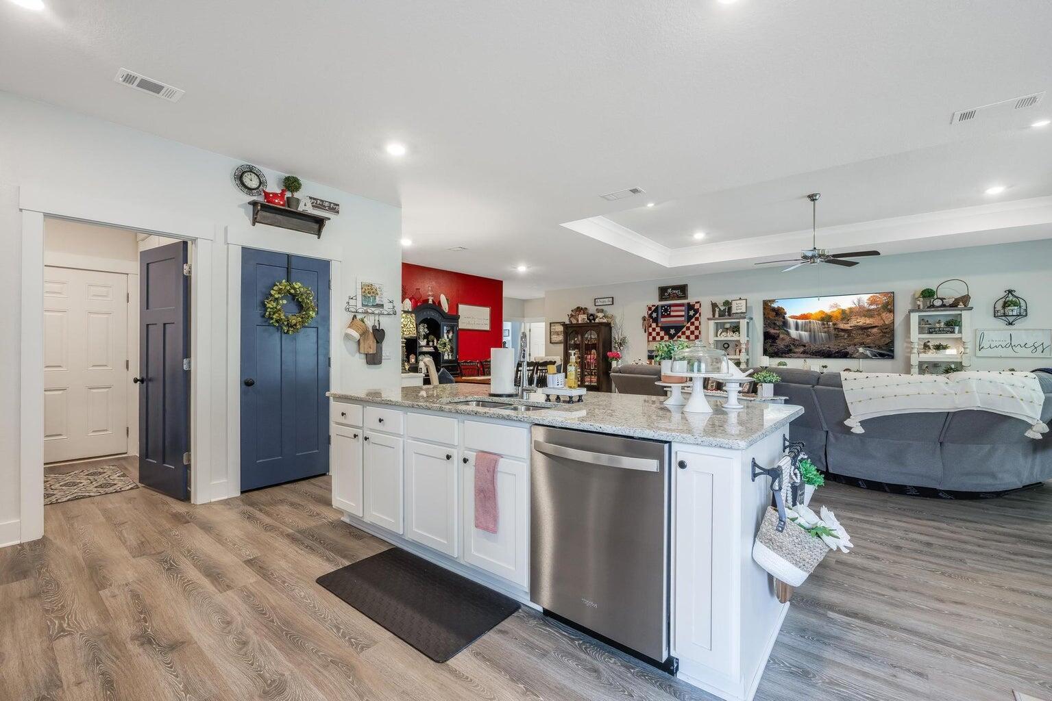 519 Mary Lou Way Crestview, FL 32539 - Photo 17 of 53 a large kitchen with stainless steel appliances granite countertop a lot of counter top space and a wooden floor