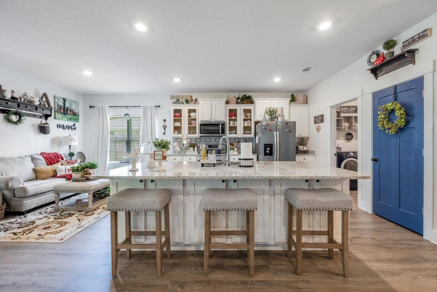 519 Mary Lou Way Crestview, FL 32539 - Photo 18 of 53 a kitchen with a dining table chairs cabinets and wooden floor