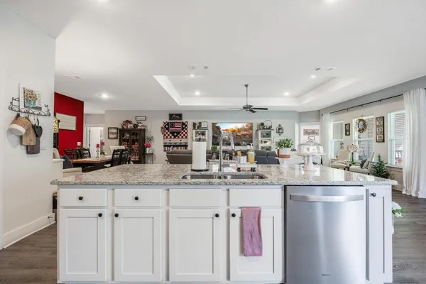a kitchen with stainless steel appliances granite countertop a refrigerator and a stove top oven