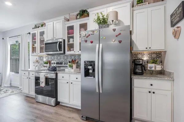 a kitchen with stainless steel appliances granite countertop a stove and a sink