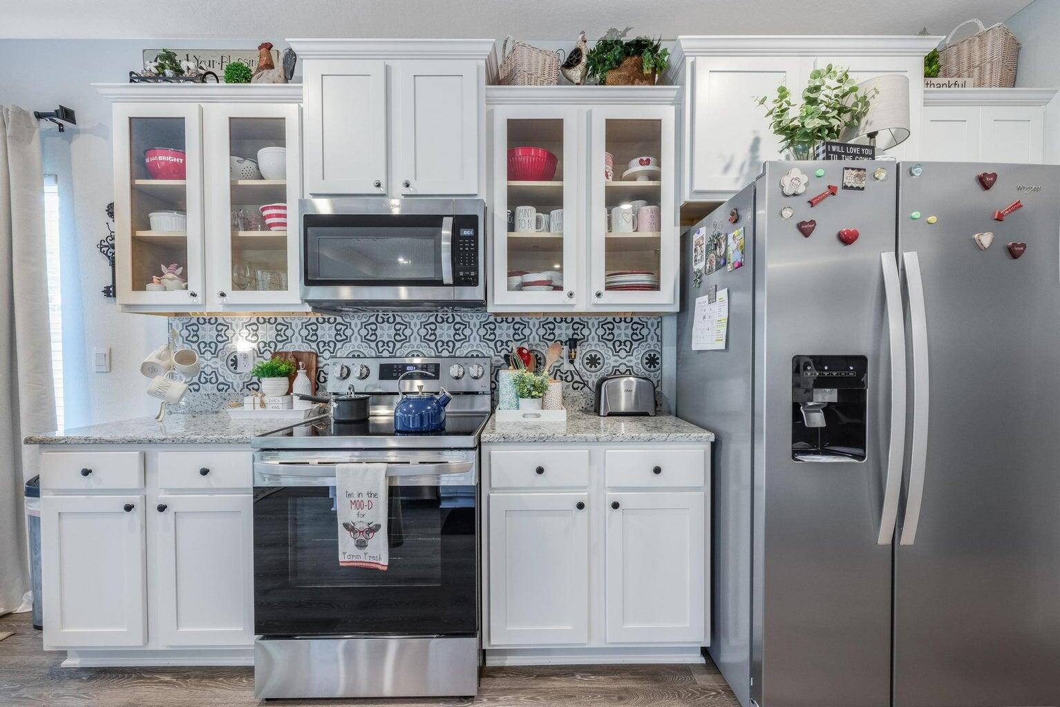 519 Mary Lou Way Crestview, FL 32539 - Photo 21 of 53 a kitchen with stainless steel appliances granite countertop a refrigerator and a stove top oven
