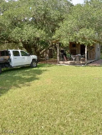 a view of a porch with a table and chairs