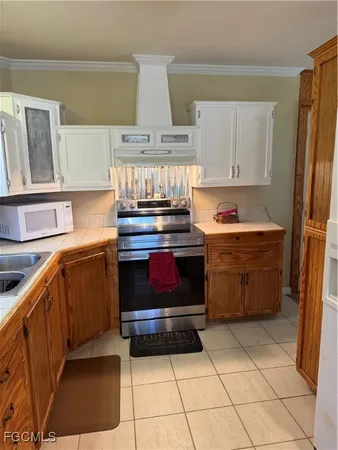 a living room with a black white checkered floor with a dining table and chairs