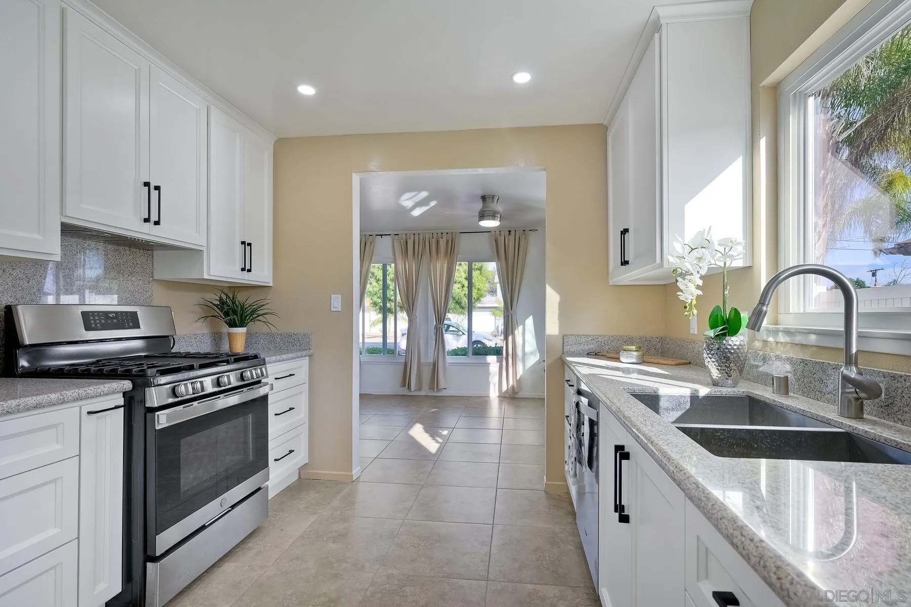 4472 Rolfe Road San Diego, CA 92117 - Photo 11 of 23 a kitchen with a sink stove top oven and cabinets