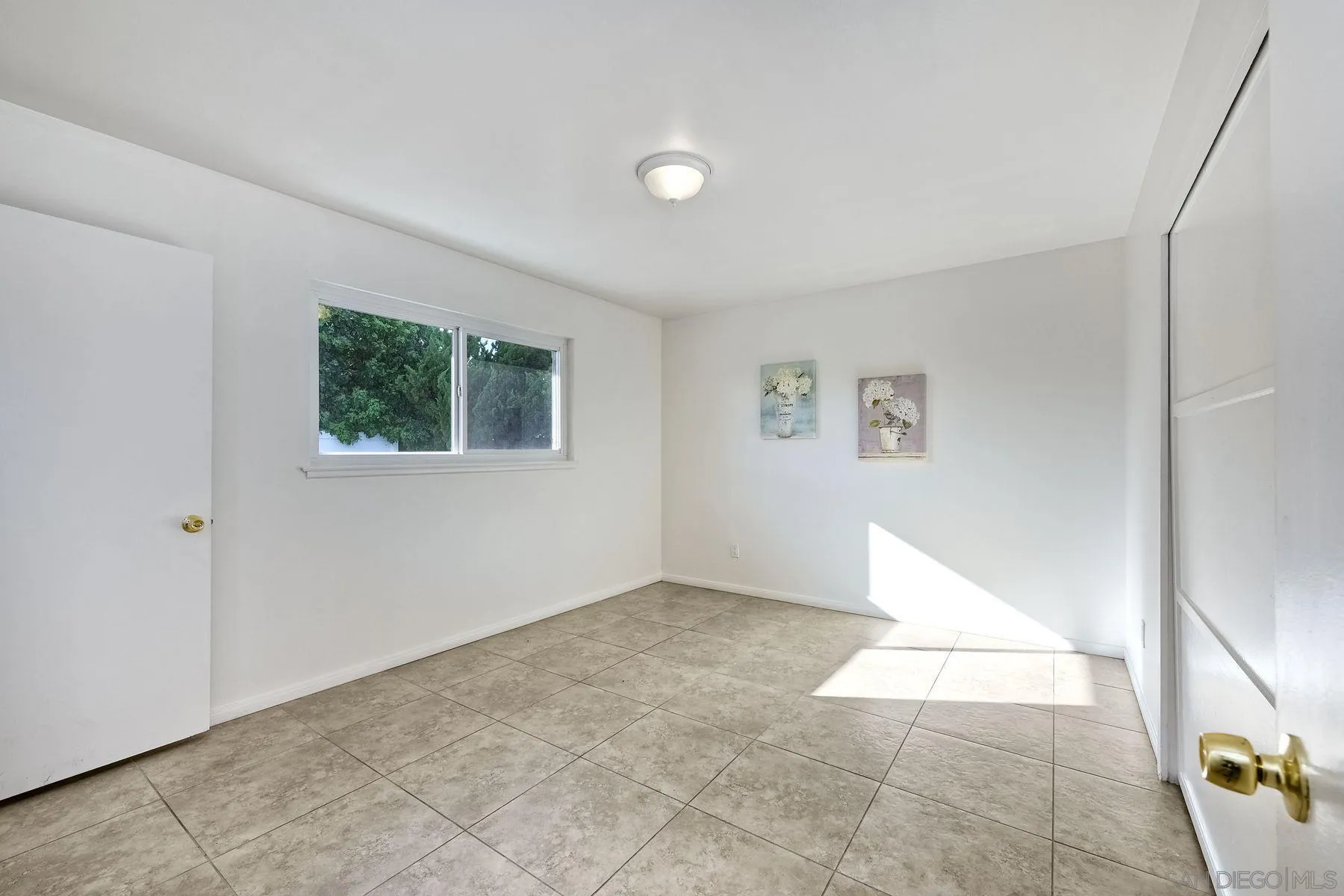 4472 Rolfe Road San Diego, CA 92117 - Photo 12 of 23 a view of an empty room with a window