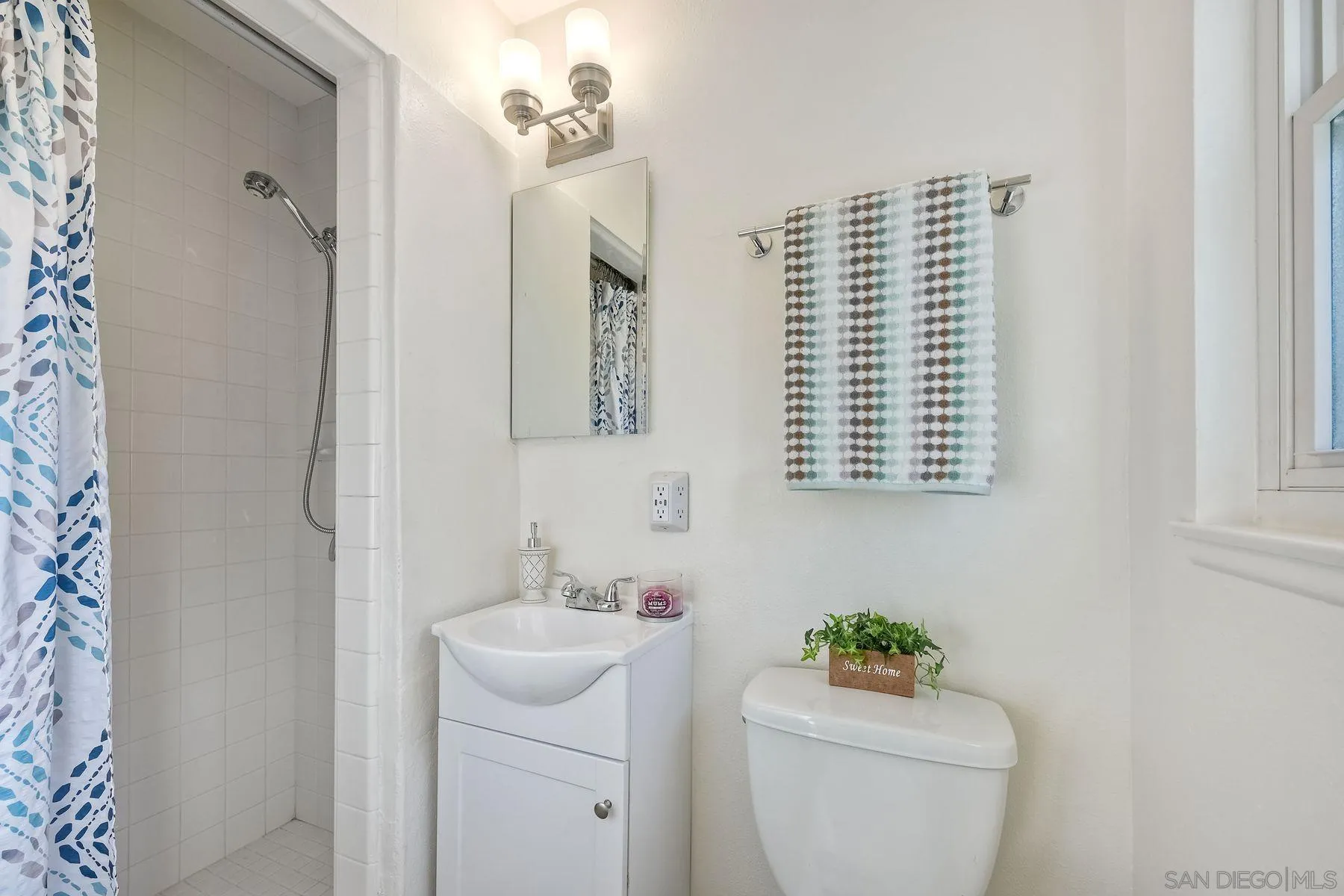 4472 Rolfe Road San Diego, CA 92117 - Photo 14 of 23 a bathroom with a sink toilet and mirror