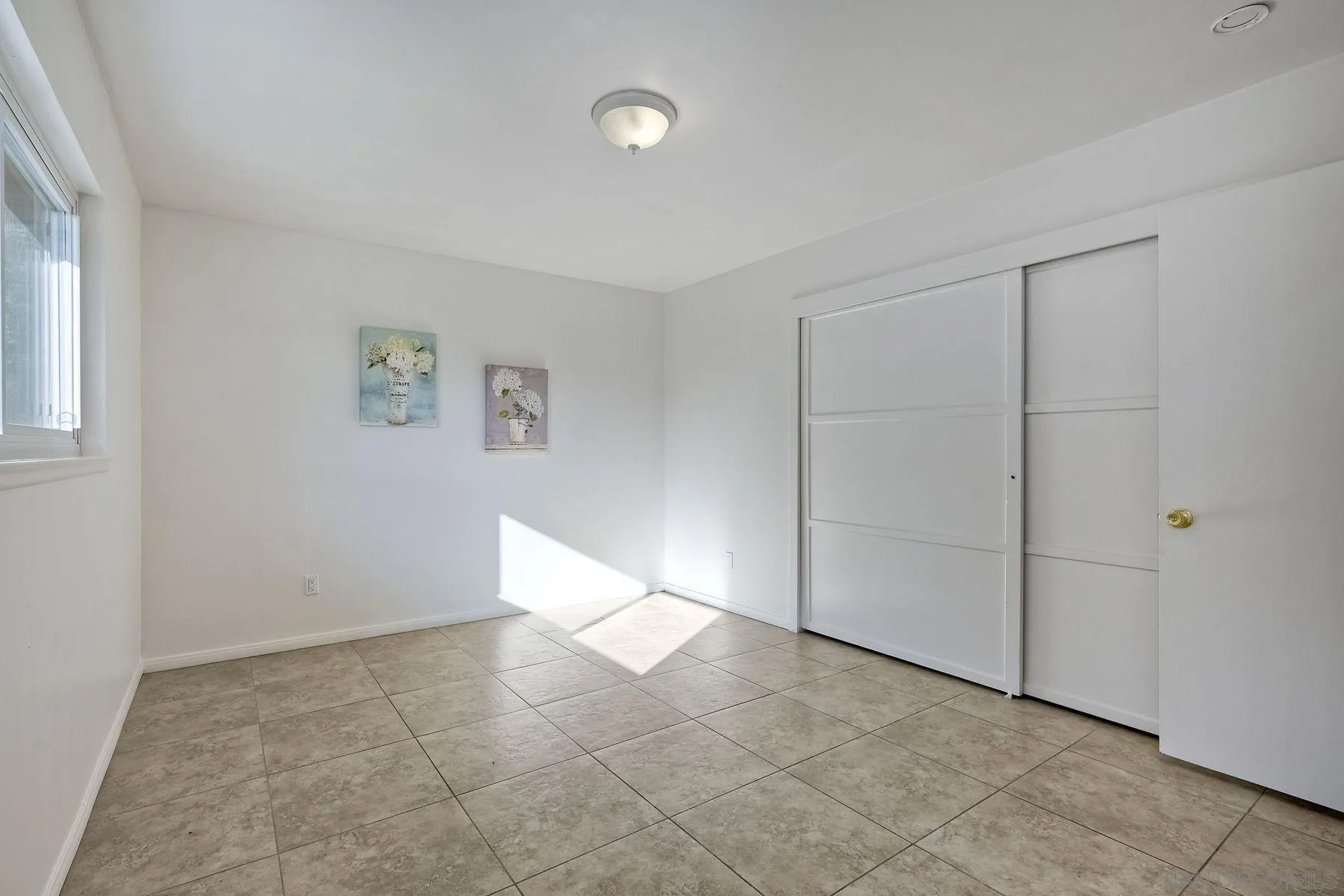 4472 Rolfe Road San Diego, CA 92117 - Photo 15 of 23 a view of an empty room with a window