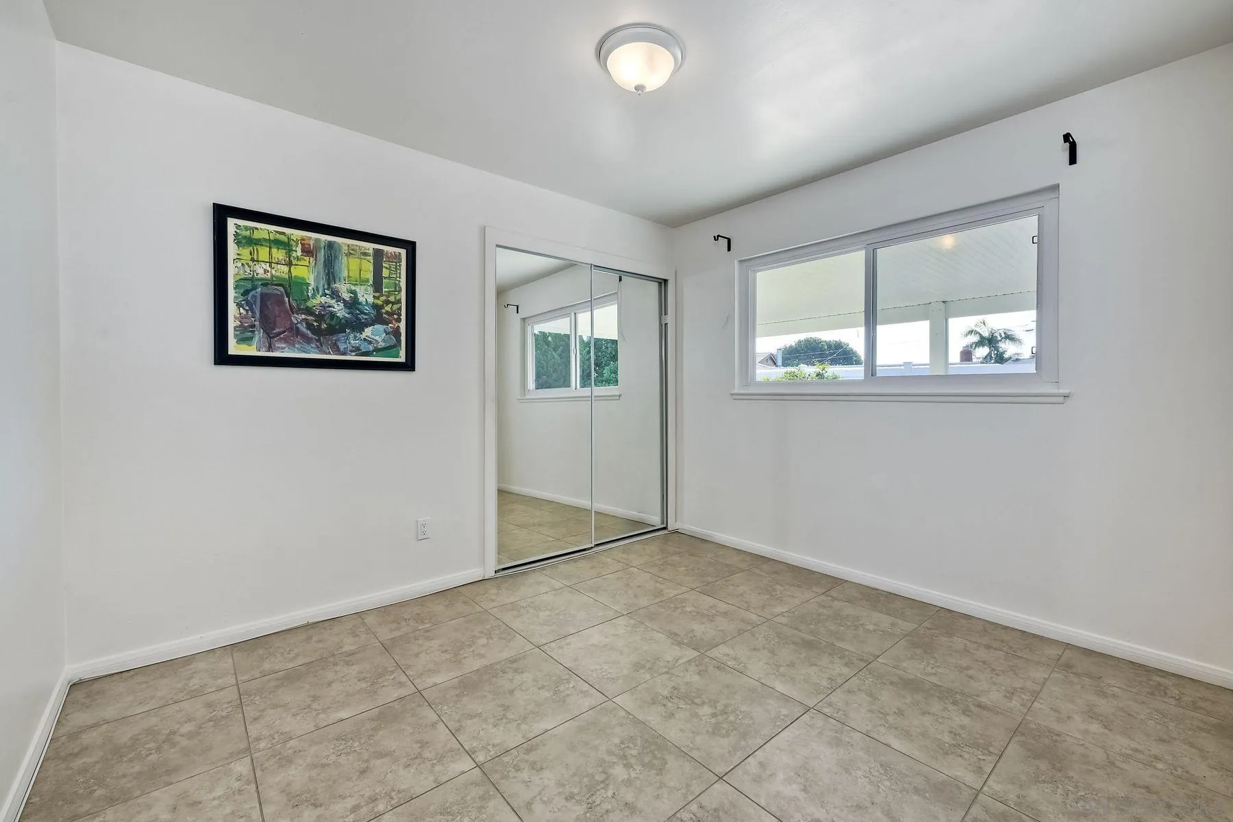 4472 Rolfe Road San Diego, CA 92117 - Photo 16 of 23 an empty room with windows