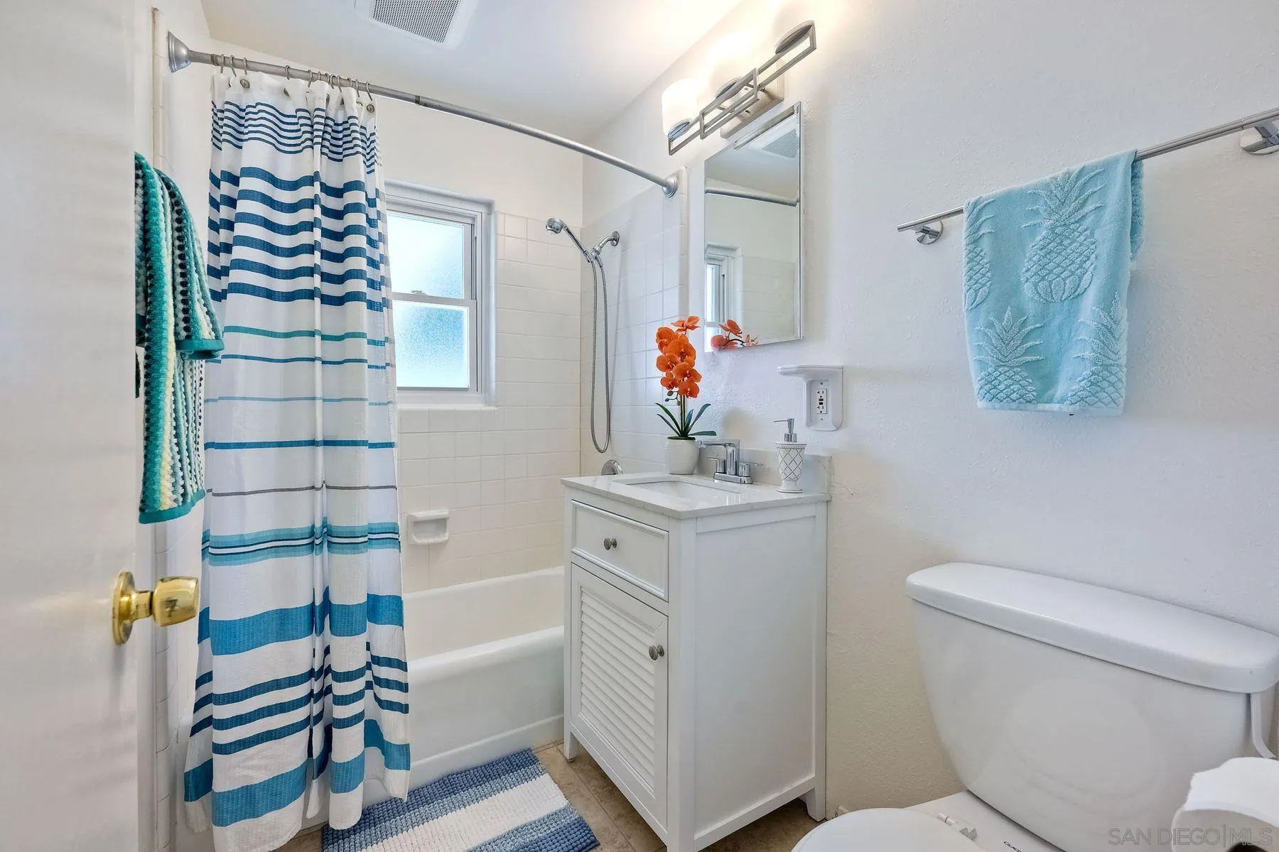 4472 Rolfe Road San Diego, CA 92117 - Photo 17 of 23 a bathroom with a sink toilet and shower