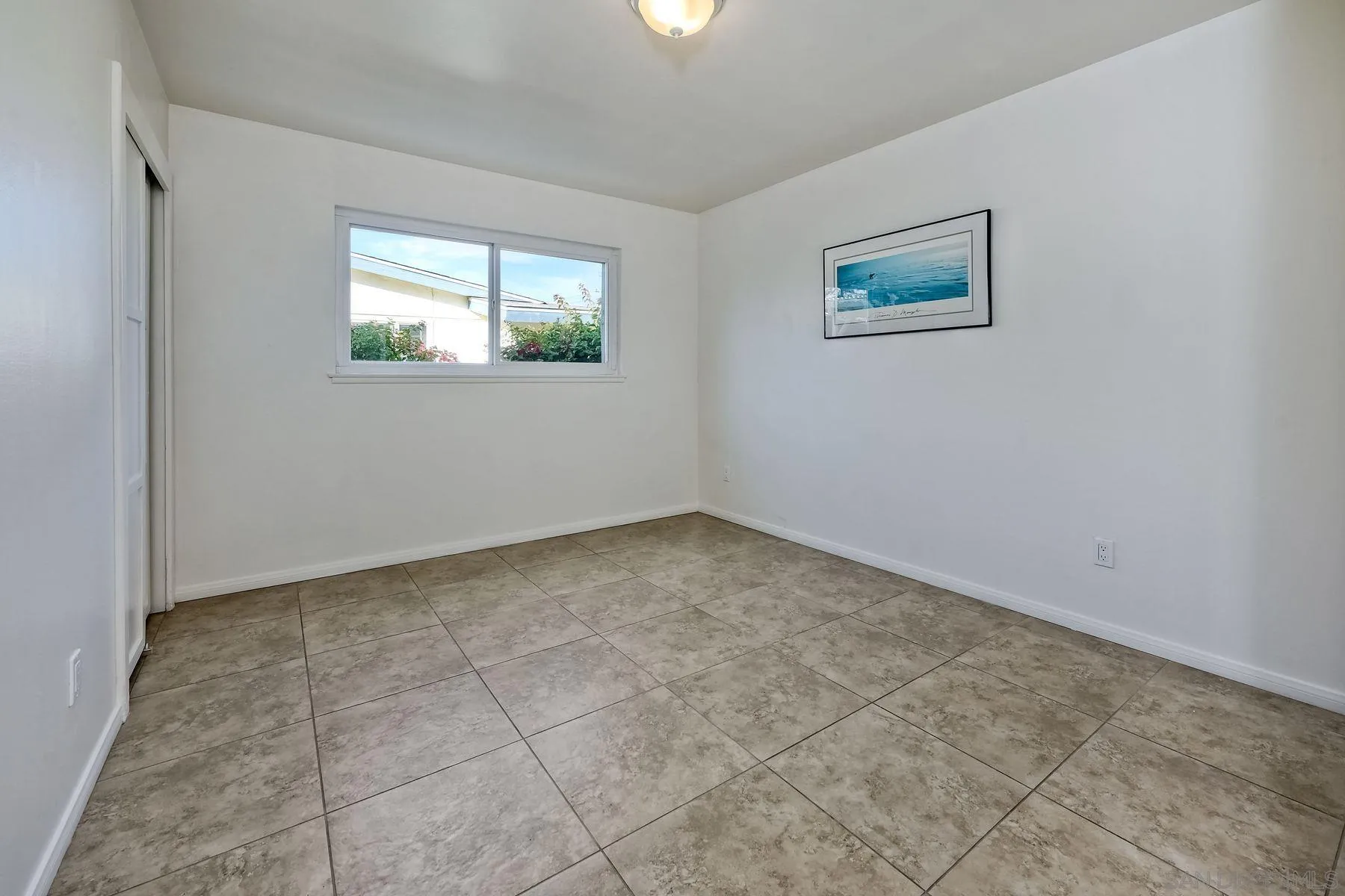 4472 Rolfe Road San Diego, CA 92117 - Photo 18 of 23 a view of an empty room with a window