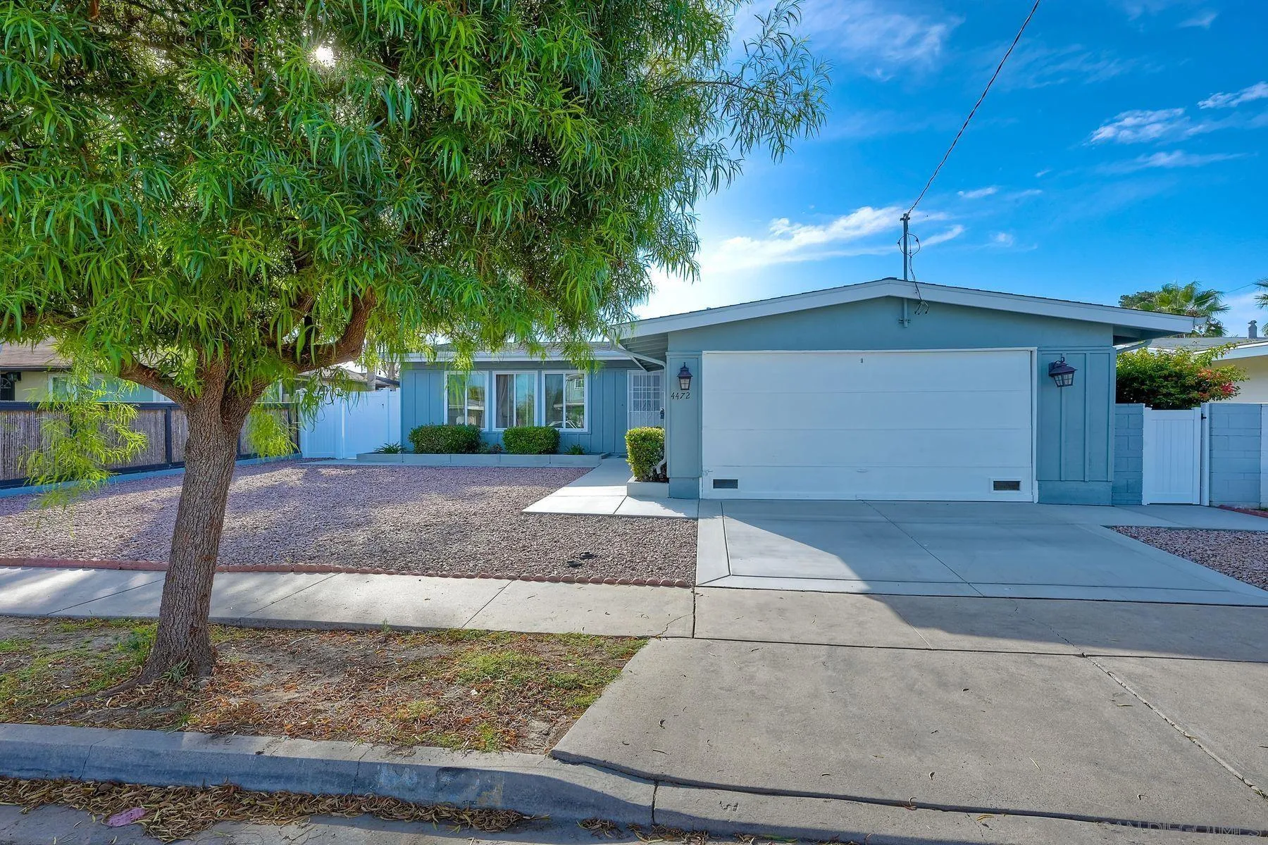 4472 Rolfe Road San Diego, CA 92117 - Photo 2 of 23 a view of a white house with a yard and large tree