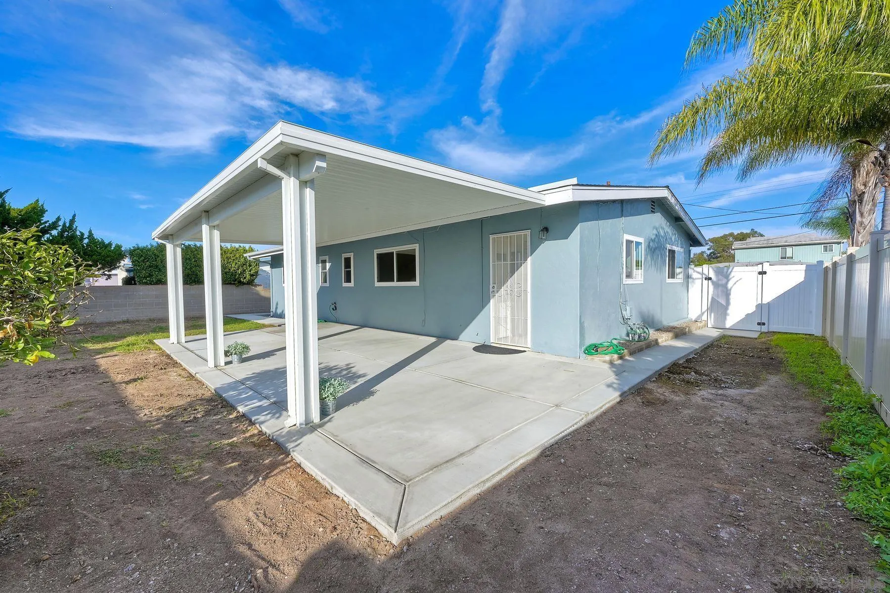 4472 Rolfe Road San Diego, CA 92117 - Photo 21 of 23 a front view of a house with a yard and potted plants