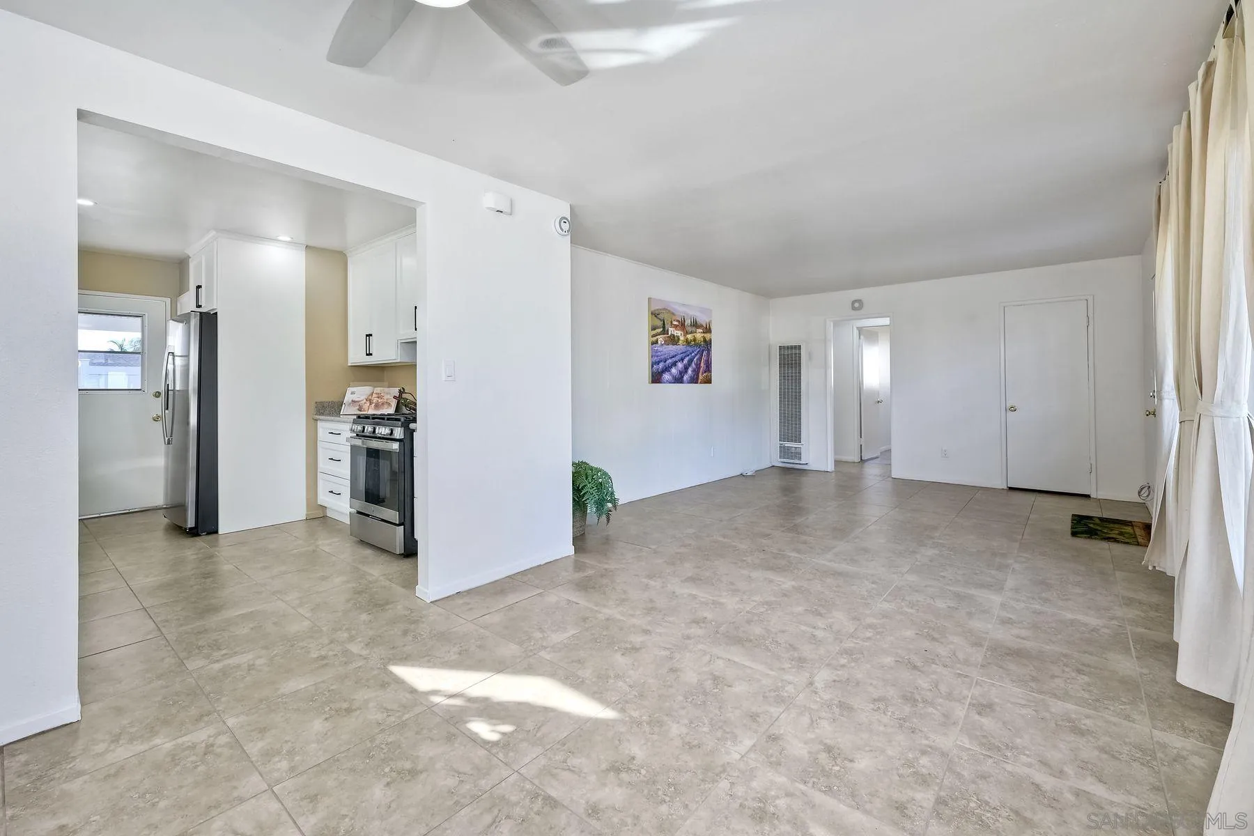 4472 Rolfe Road San Diego, CA 92117 - Photo 8 of 23 an empty room with furniture and view of bathroom