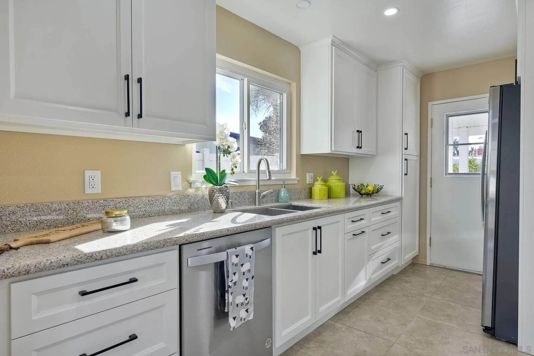 4472 Rolfe Road San Diego, CA 92117 - Photo 9 of 23 a bathroom with a granite countertop sink and a mirror