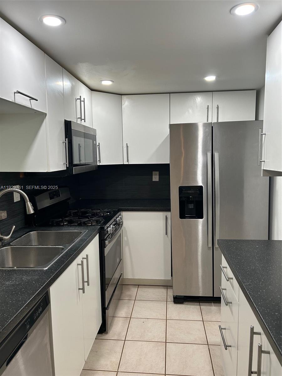 2201 Brickell Avenue, Unit 29 Miami, FL 33129 - Photo 4 of 9 a kitchen with stainless steel appliances granite countertop a refrigerator and a sink