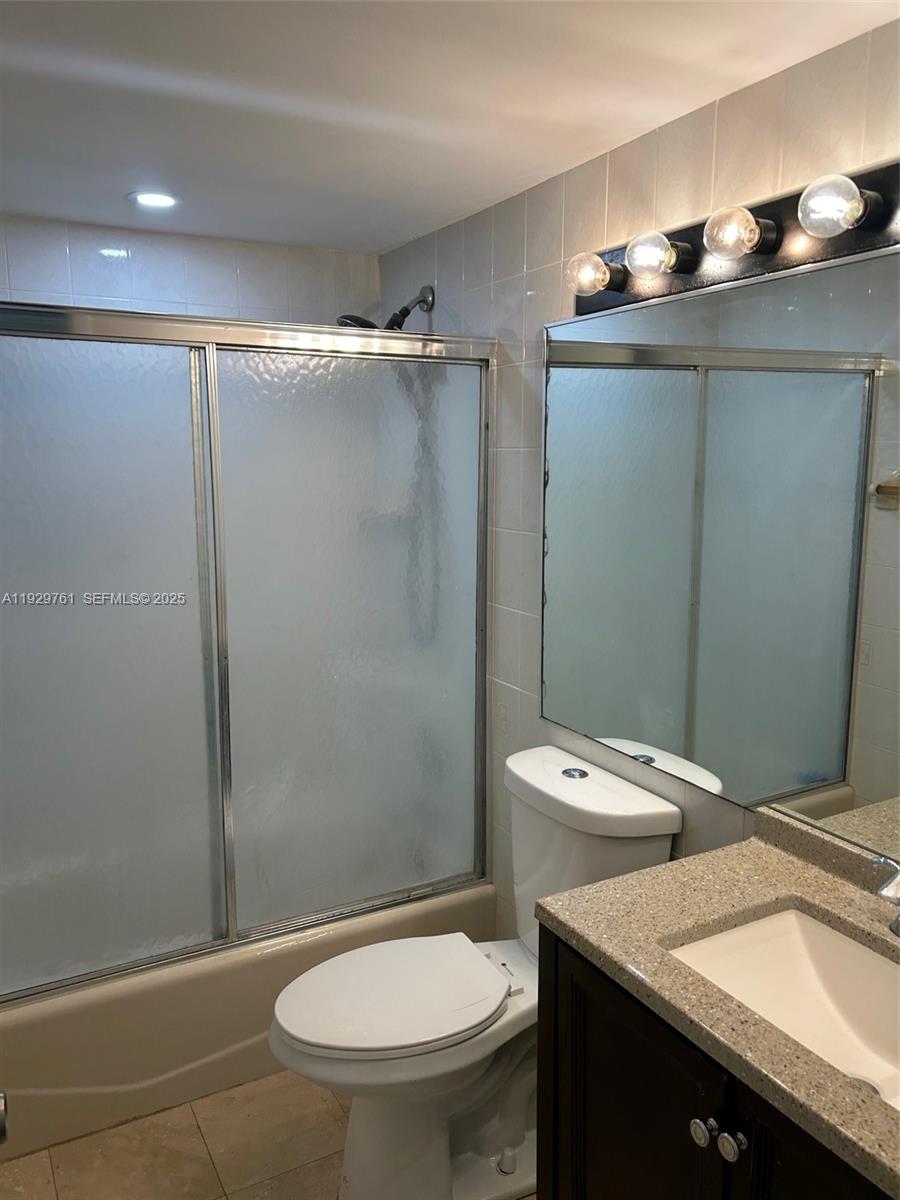 2201 Brickell Avenue, Unit 29 Miami, FL 33129 - Photo 8 of 9 a bathroom with a toilet a sink and shower