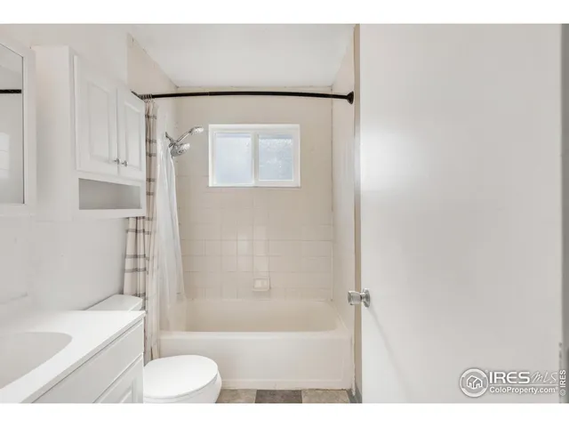 a bathroom with a bathtub and a toilet