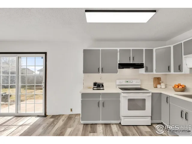 a kitchen with a stove a sink and a refrigerator