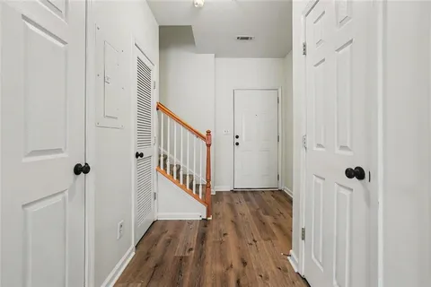 a view of a hallway with wooden floor and entryway