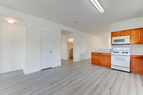 a view of a kitchen with a sink and a stove top oven
