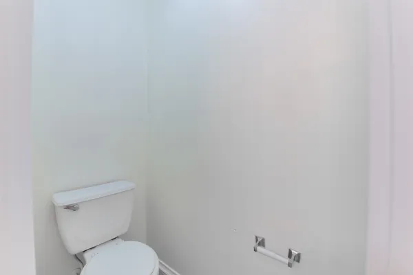 a white toilet sitting next to a white sink
