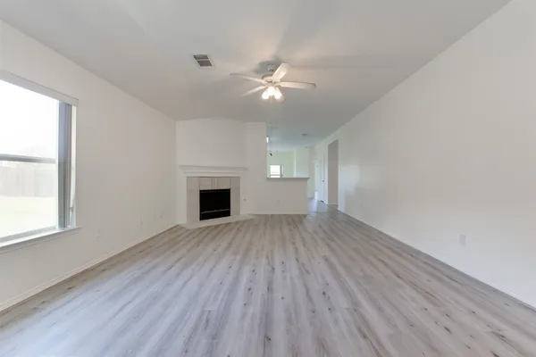 wooden floor in an empty room with a window