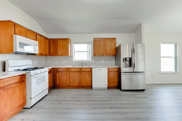 a kitchen with a stove a sink and a refrigerator