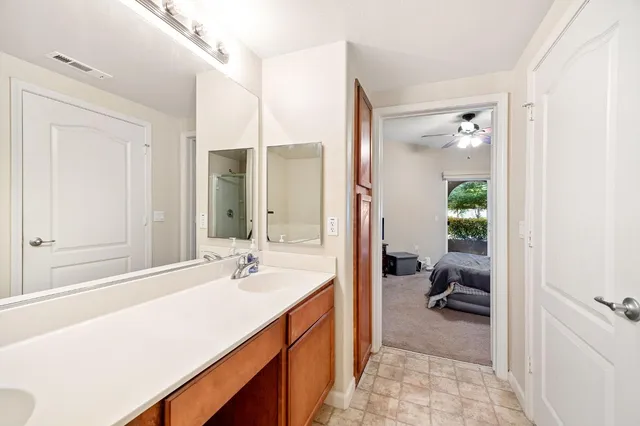 a en suite bathroom with a sink and a mirror