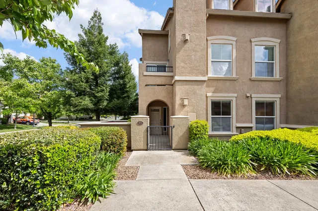 a front view of a house with garden
