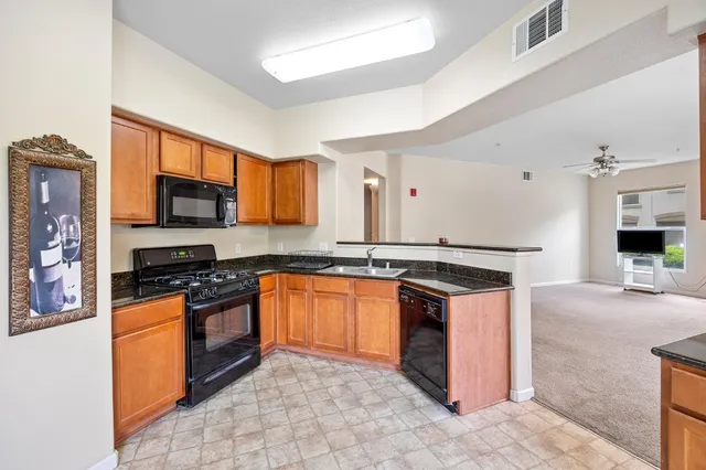 a kitchen with stainless steel appliances granite countertop a stove sink and cabinets