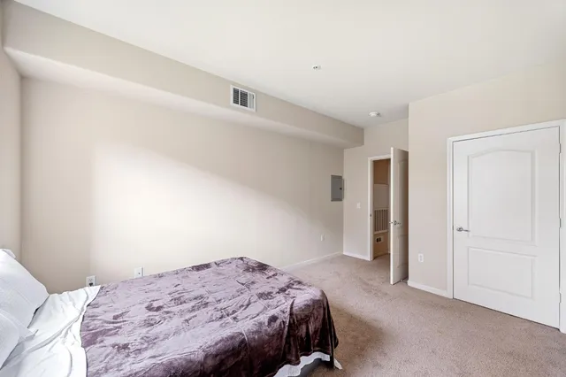 a bedroom with a bed and a cabinets