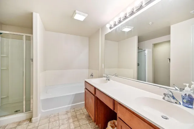 a bathroom with a sink double vanity and a shower
