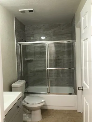 a bathroom with a shower and a toilet