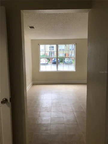 a view of an empty room with a window