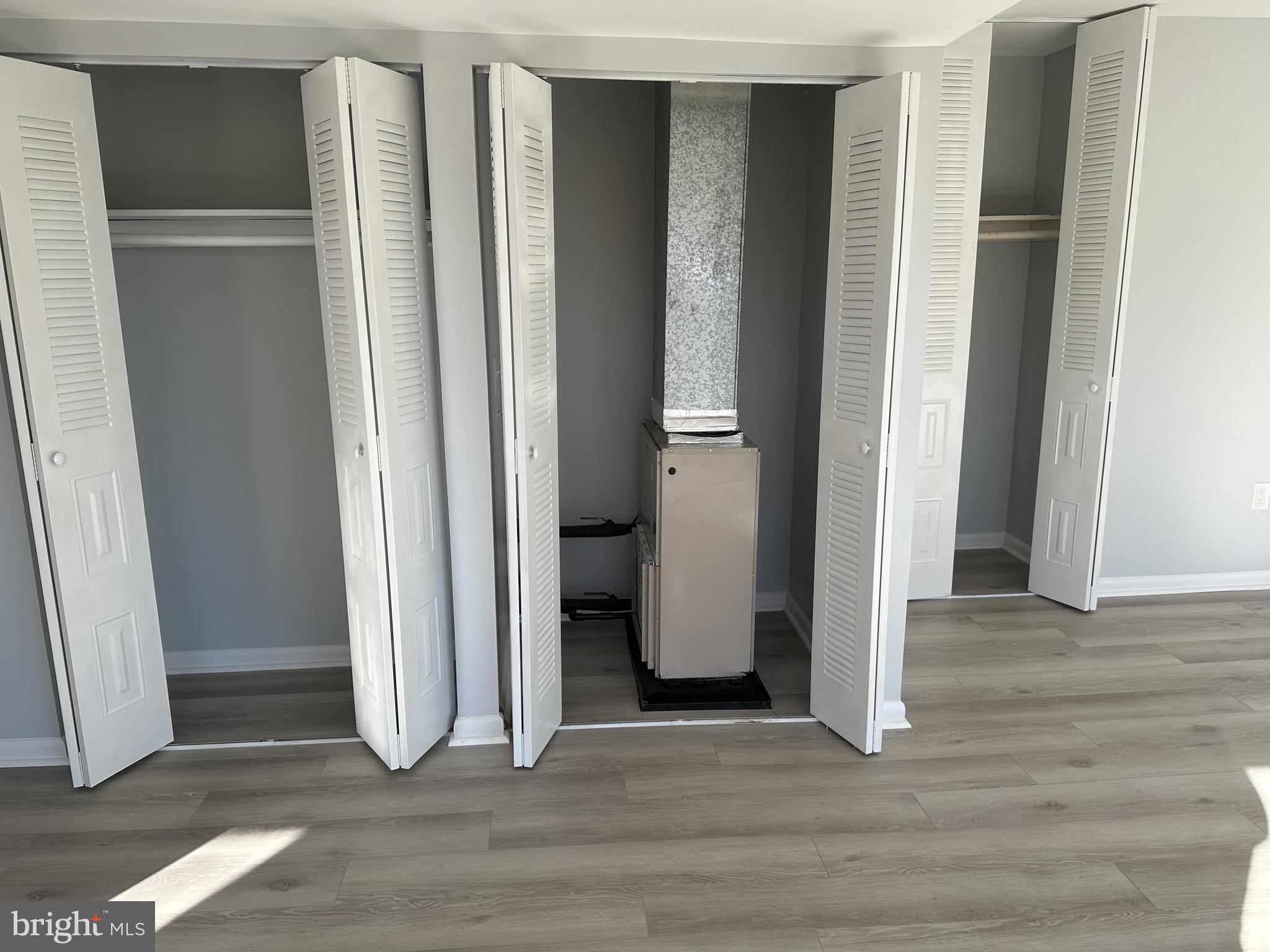 7967 Riggs Road, Unit 796710 Hyattsville, MD 20783 - Photo 7 of 11 an empty room with wooden floor and closet