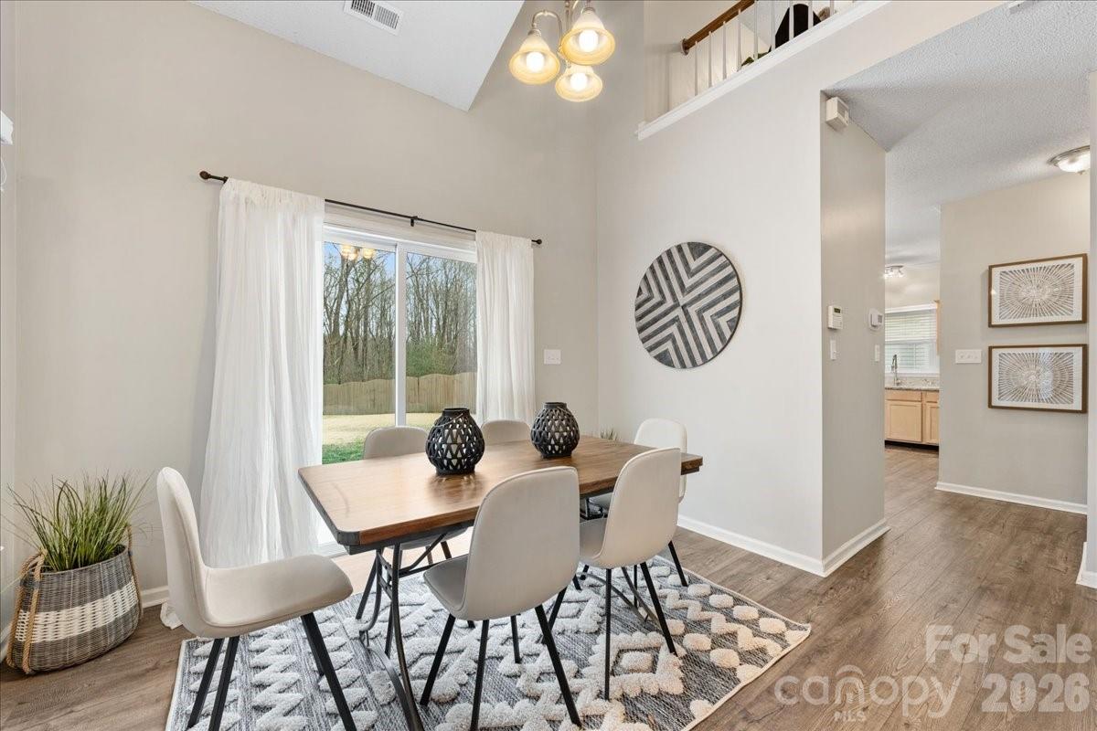 7800 Trotter Road Charlotte, NC 28216 - Photo 12 of 46 a view of a dining room with furniture and wooden floor