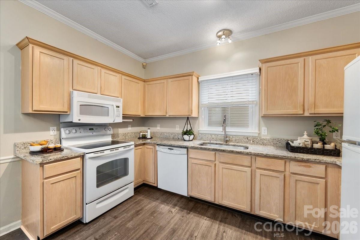 7800 Trotter Road Charlotte, NC 28216 - Photo 16 of 46 a kitchen with granite countertop white cabinets and white appliances