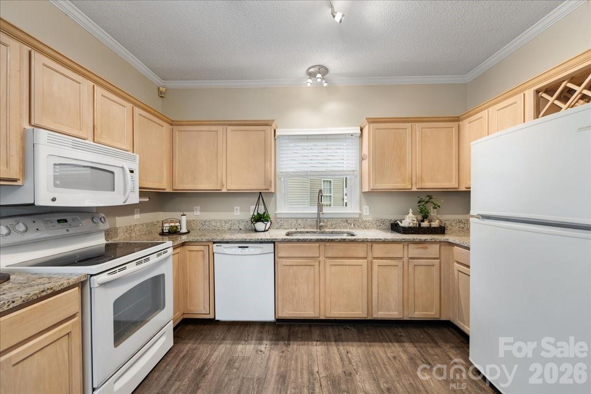 7800 Trotter Road Charlotte, NC 28216 - Photo 17 of 46 a kitchen with stainless steel appliances a sink a stove a refrigerator cabinets and a window