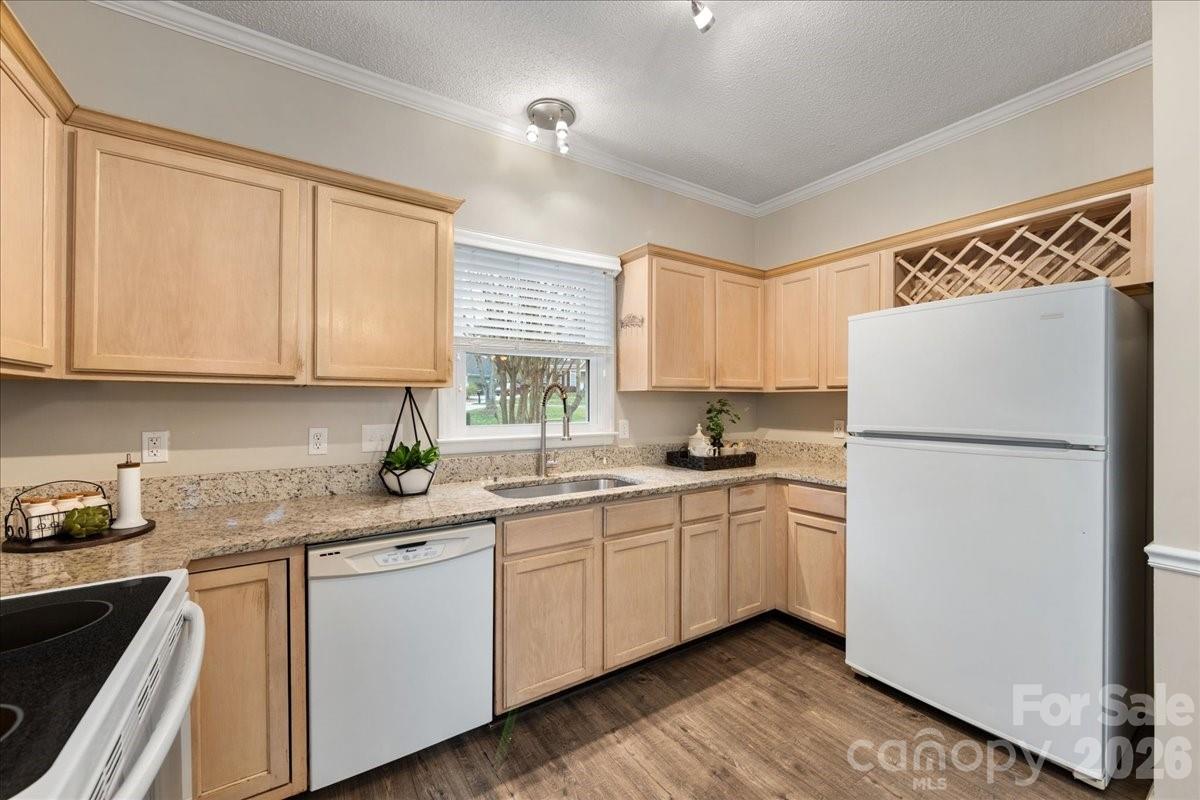 7800 Trotter Road Charlotte, NC 28216 - Photo 18 of 46 a kitchen with white cabinets sink and white appliances