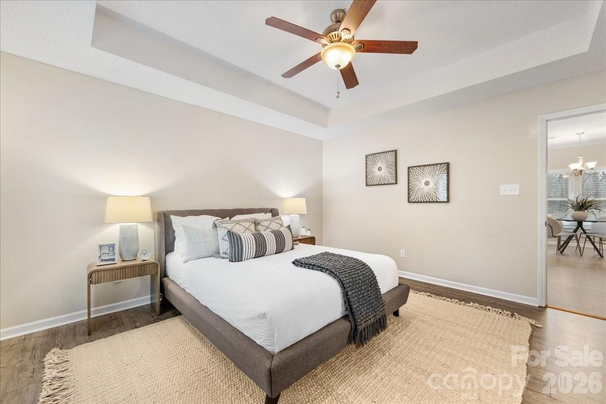 7800 Trotter Road Charlotte, NC 28216 - Photo 23 of 46 a bedroom with a large bed and a chandelier